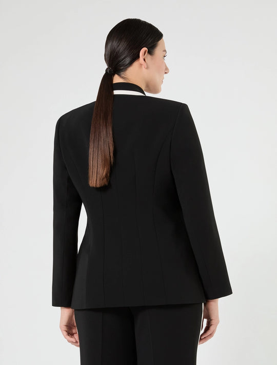 Black blazer back view with white contrast collar and sleeve cuffs