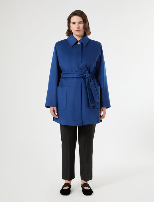 Short wool coat in bright blue with self-tie belt, patch pockets, and covered button placket, front view