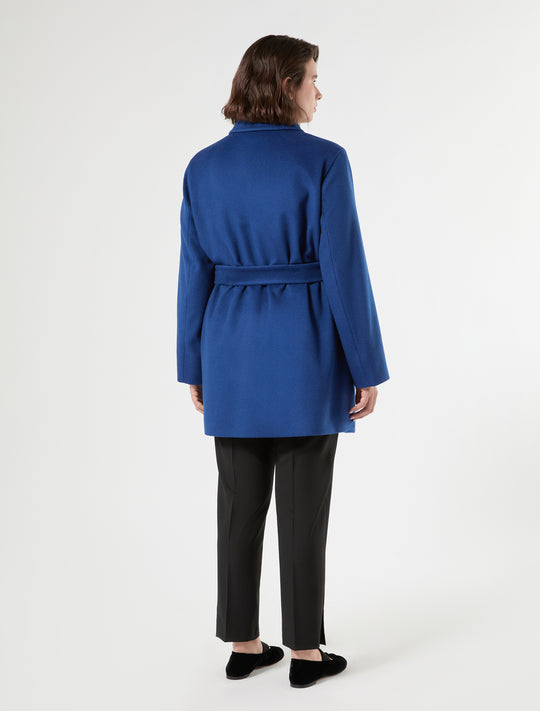 Short wool coat with self belt and clean back view, worn with black trousers