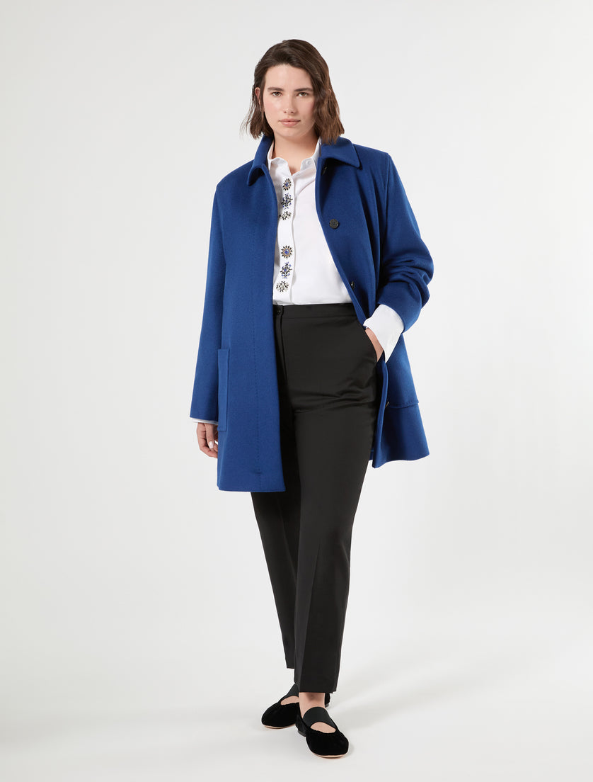 Royal blue wool short coat with covered button placket, worn open over white shirt and black trousers