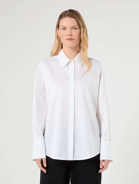 White cotton poplin button-up shirt on model, pointed collar and button front
