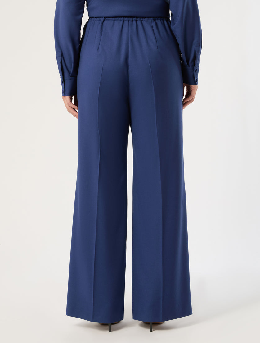 Wide-leg wool trousers with elastic waist and center back seam, rear view on model
