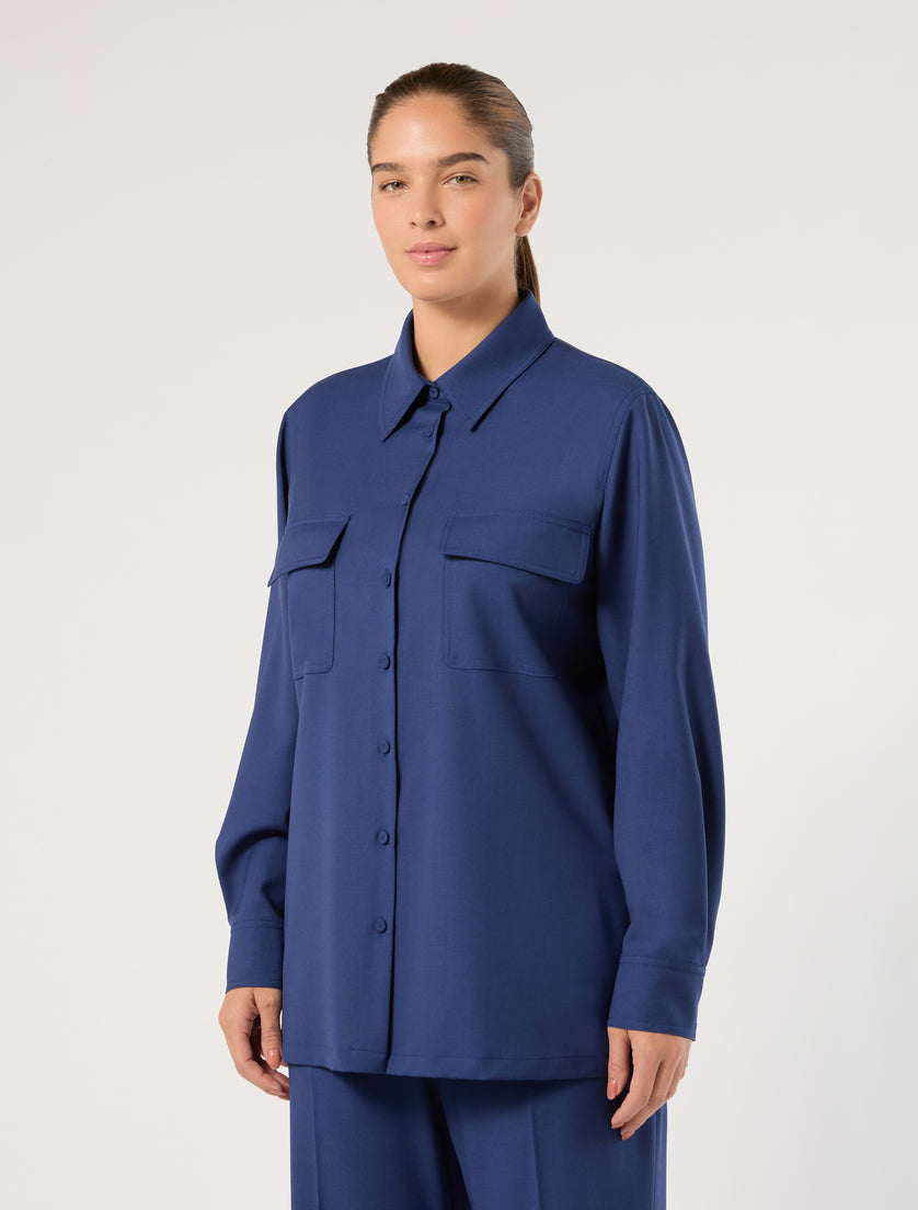 Oversized long-sleeve button-front shirt jacket with dual chest flap pockets, front three-quarter view