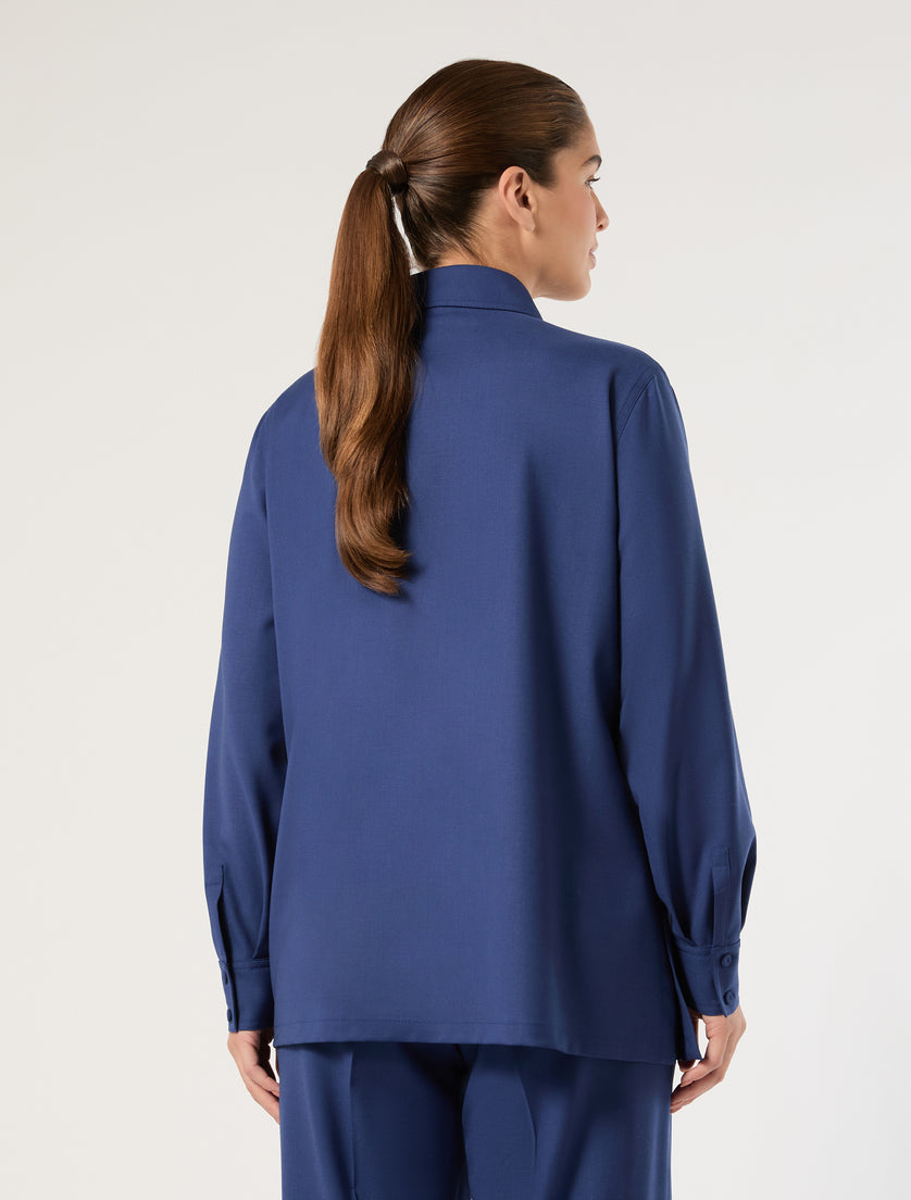 Blue long-sleeve wool shirt jacket, back view on model with ponytail, relaxed fit