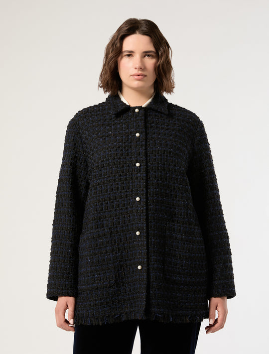 Oversized dark tweed jacket with pearl buttons, fringed hem, and patch pockets, front view on model