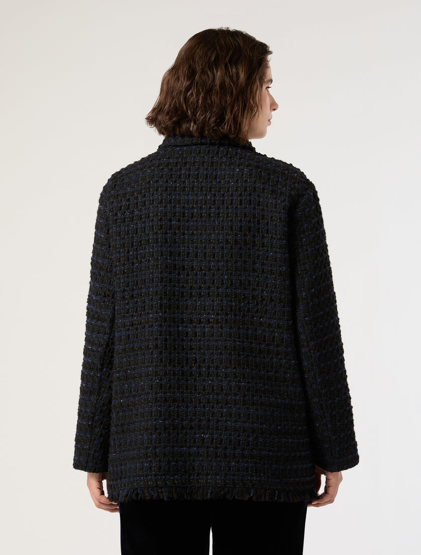 Textured tweed jacket with fringed hem shown from the back on a model, dark blue-black colorway