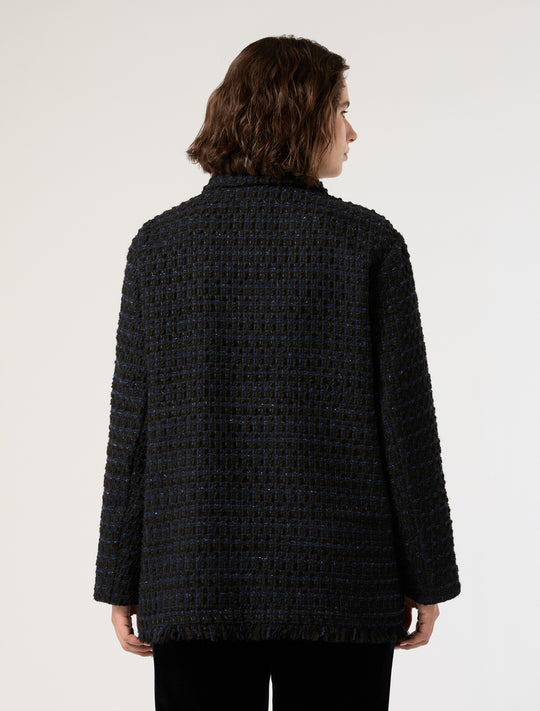 Textured tweed jacket with fringed hem shown from the back on a model, dark blue-black colorway