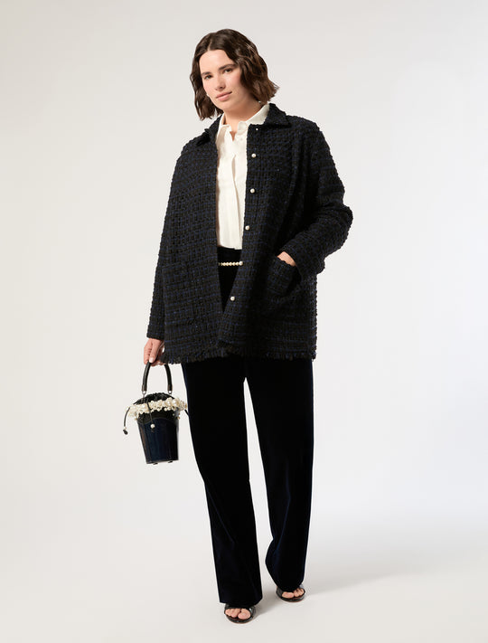 Dark textured tweed jacket with fringed hem and pearl buttons, worn open over white blouse