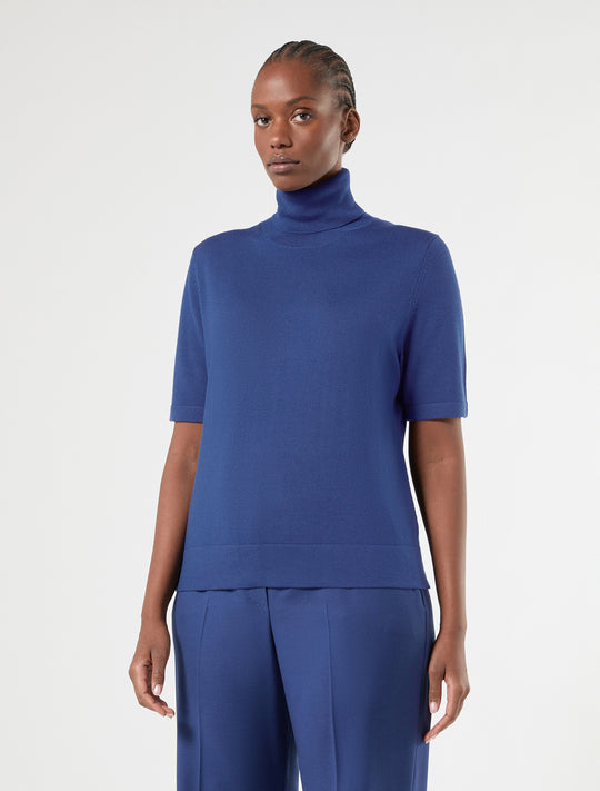 Short-sleeve turtleneck knit sweater in blue, front view on model