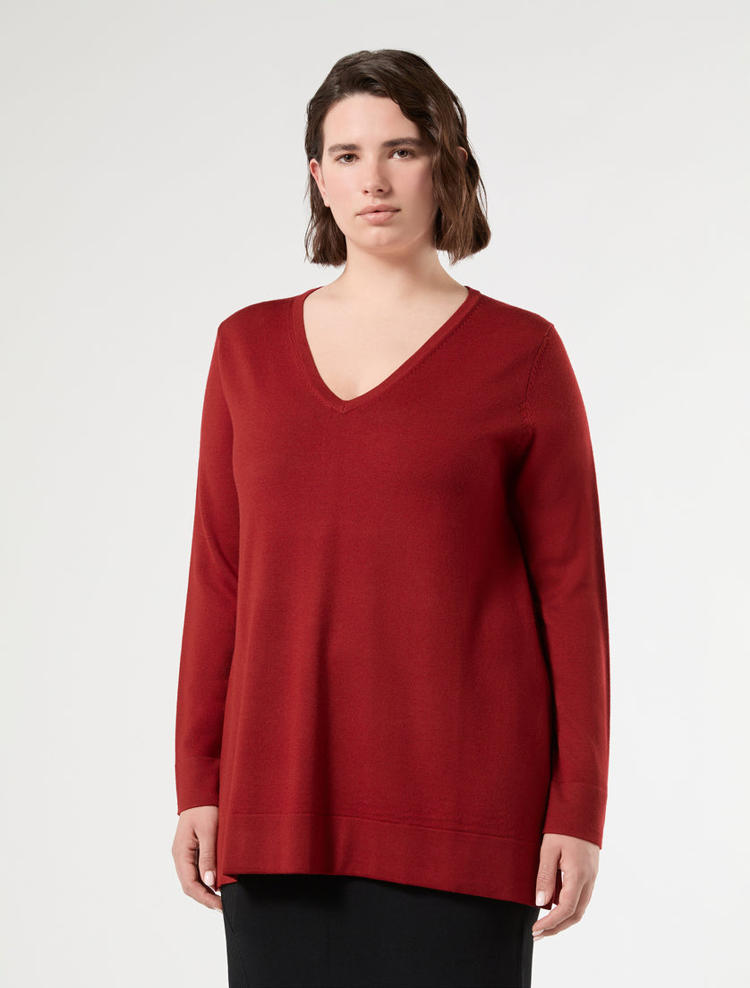 Deep red V-neck long sleeve knit sweater, relaxed fit, worn by model, front view