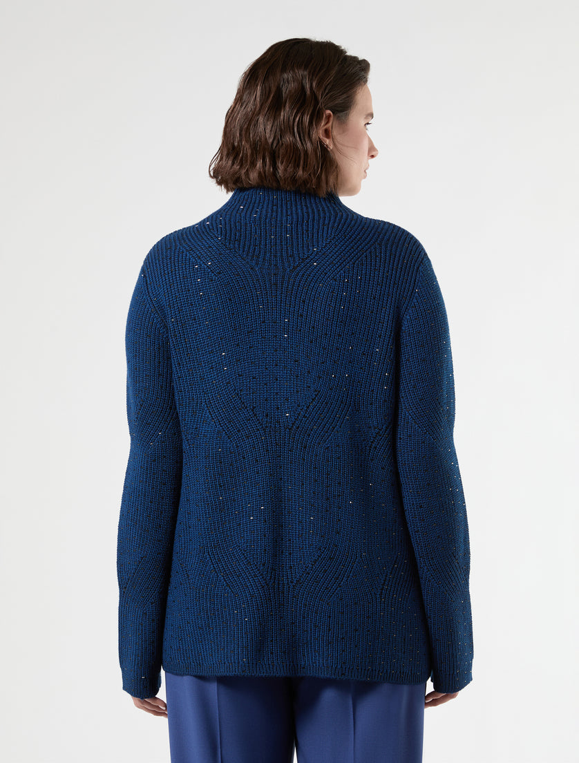 Blue-black knit mock neck sweater with heat-set studs, back view on model