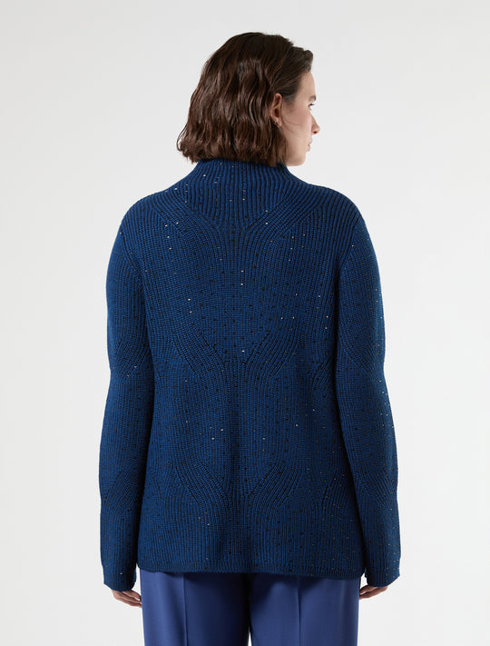 Blue-black knit mock neck sweater with heat-set studs, back view on model