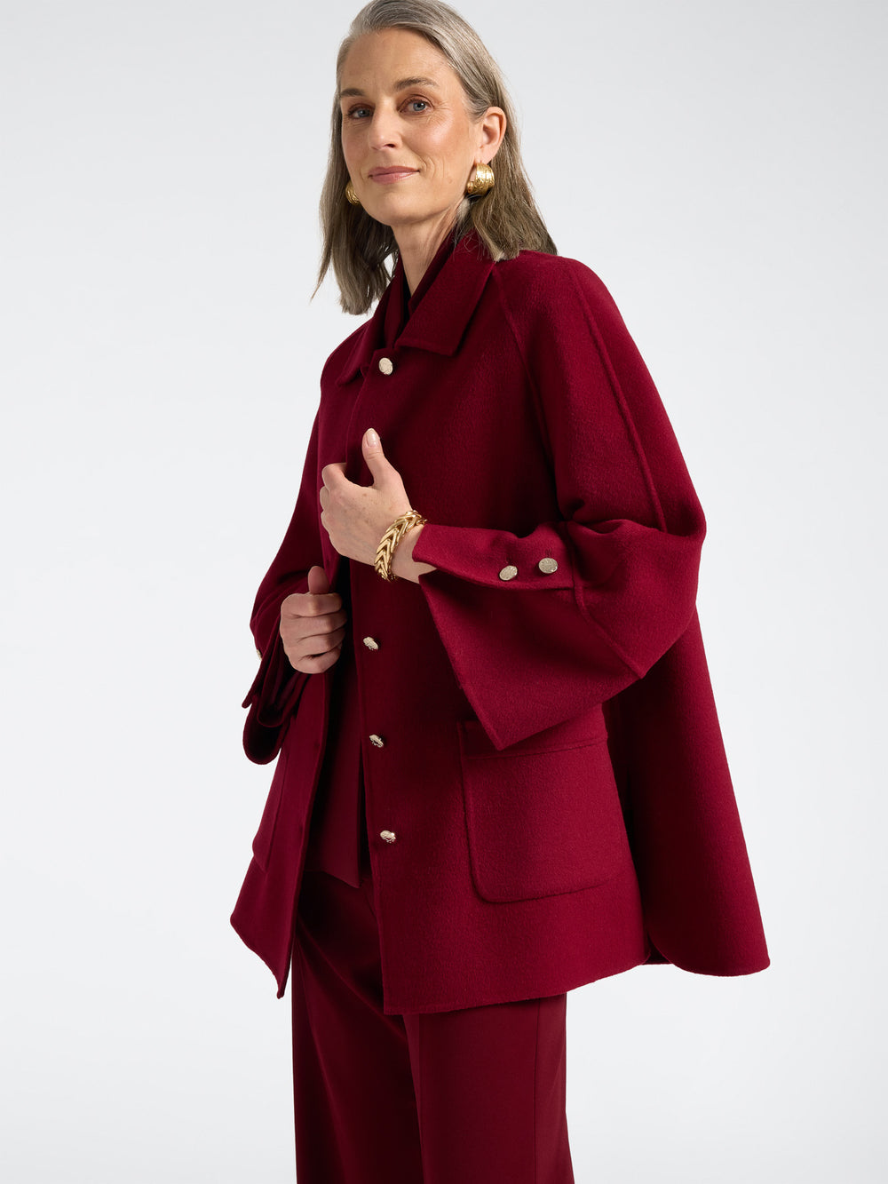 Red double-face coat with button front, deep pockets, and buttoned cuff