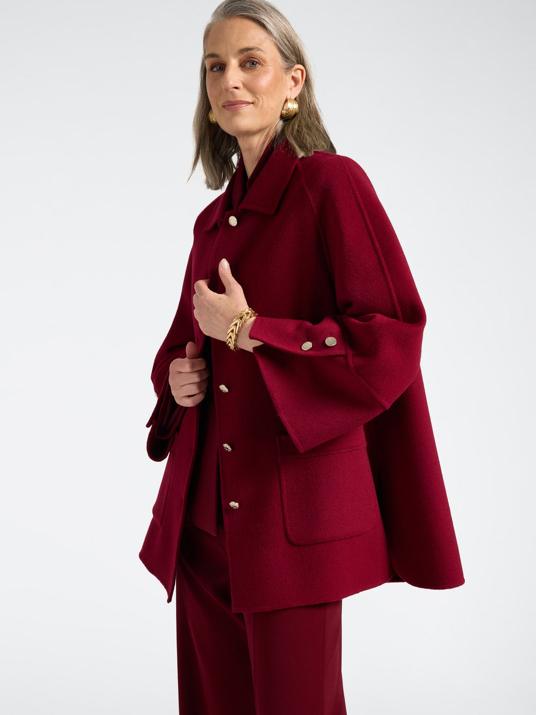 Red double-face coat with button front, deep pockets, and buttoned cuff