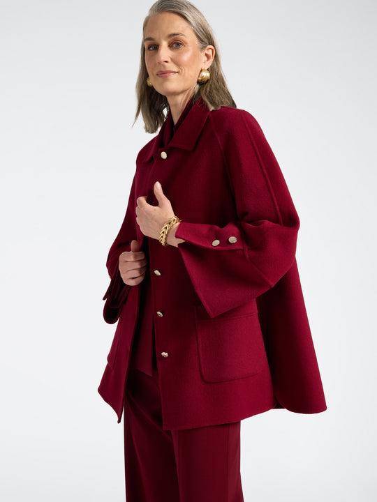 Red double-face coat with button front, deep pockets, and buttoned cuff