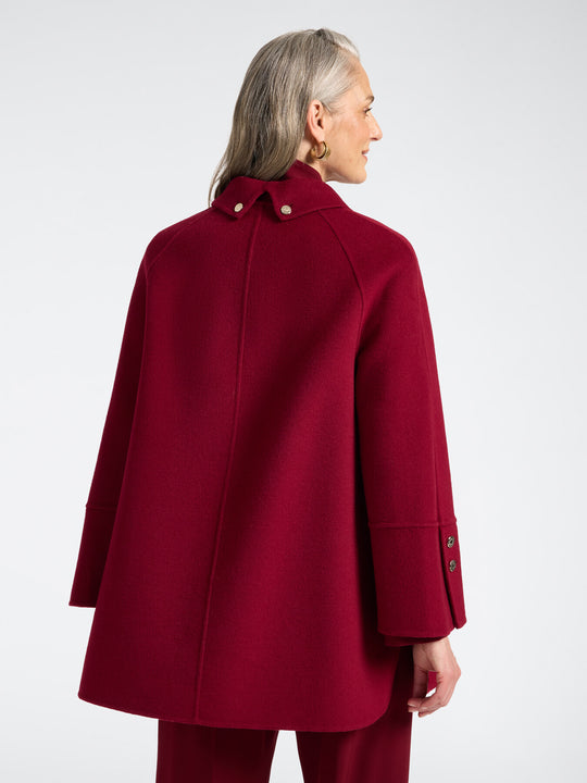 Red double-face coat, back view with structured shoulders and buttoned cuff