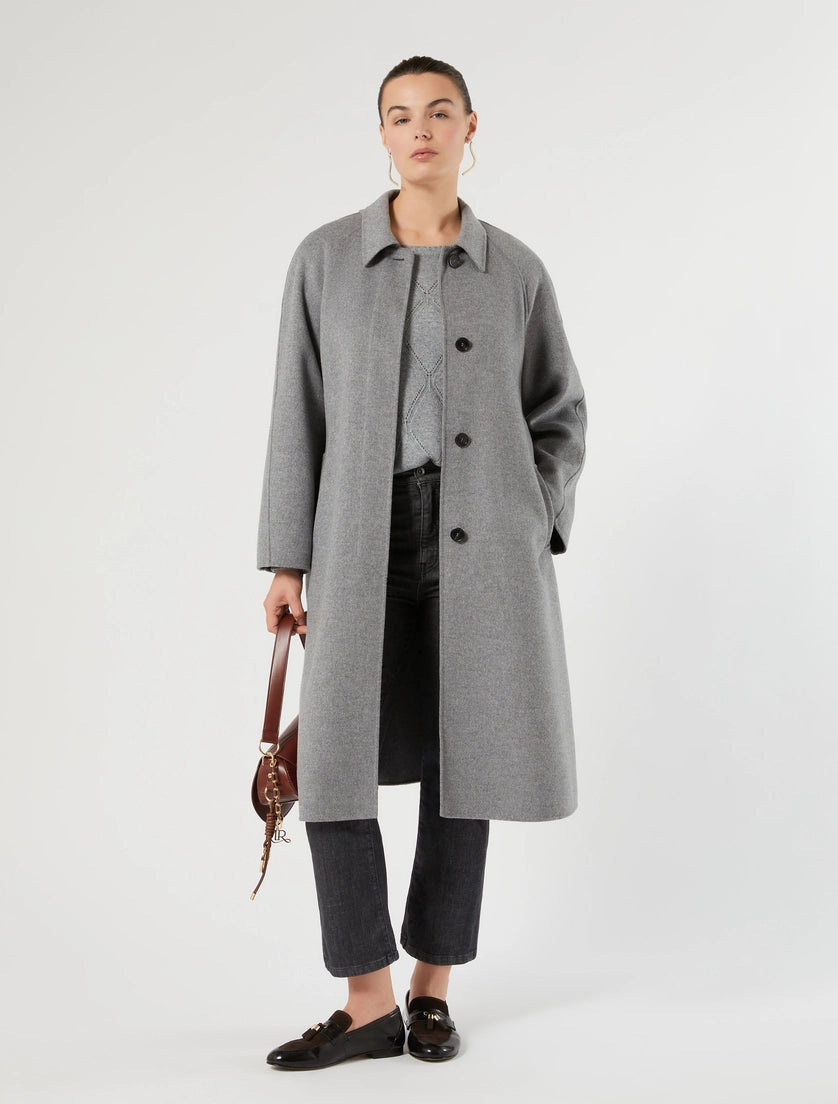 Grey knit long-sleeve pullover peeking at neckline under open-front coat