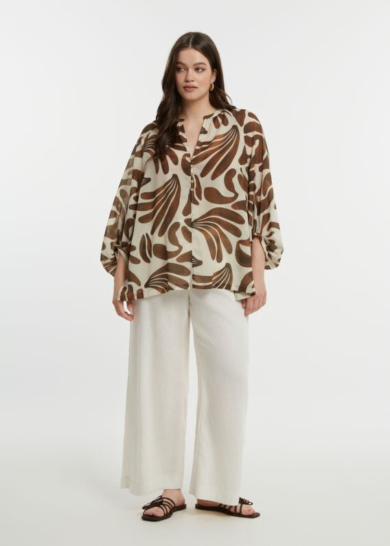 front view of plus size Mat Print Blouse with Split Neck in Caramel with white pant