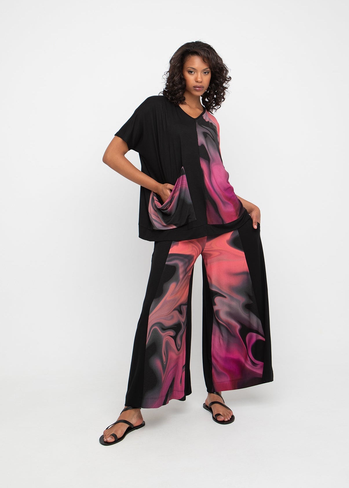 front view of plus size Ozai N Ku V Neck Pink Print Black Mix Boxy Top with Pocket in Rose