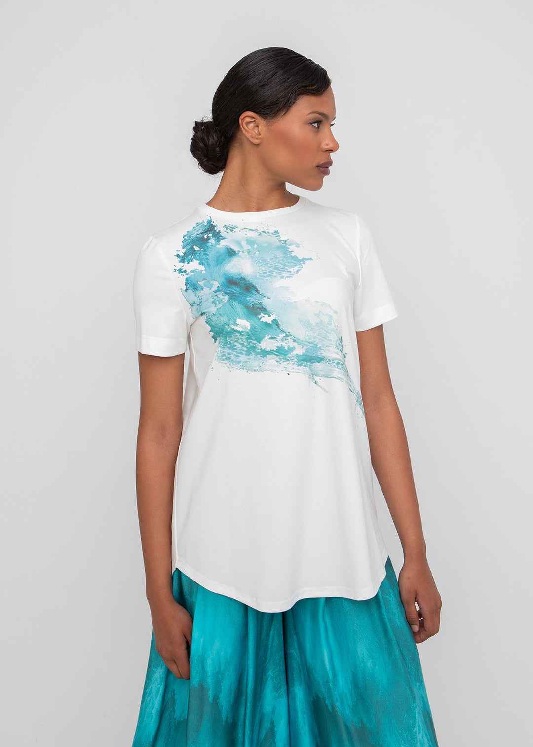 front view of plus size Ozai N Ku Short Sleeve Curved Hem Tee with Placed Print in White