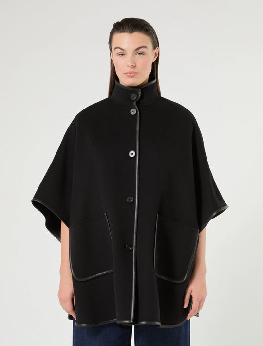 Black cape with stand collar and snap-button closure, faux leather-trimmed hem panels.