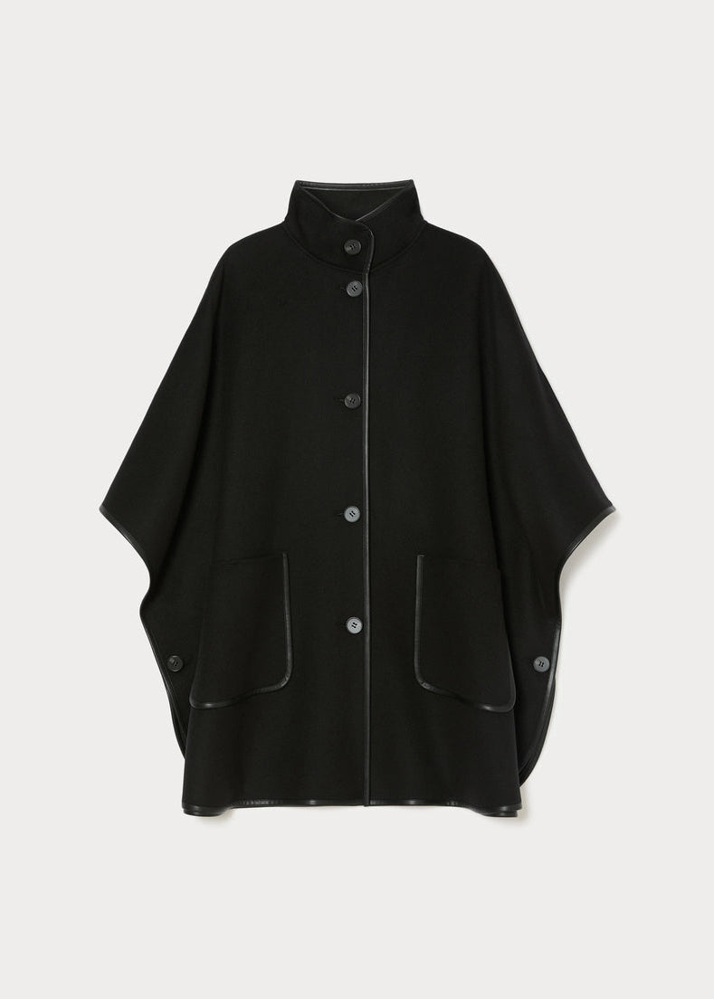 Black poncho-style cape with stand collar, snap buttons, and patch pockets; front view.