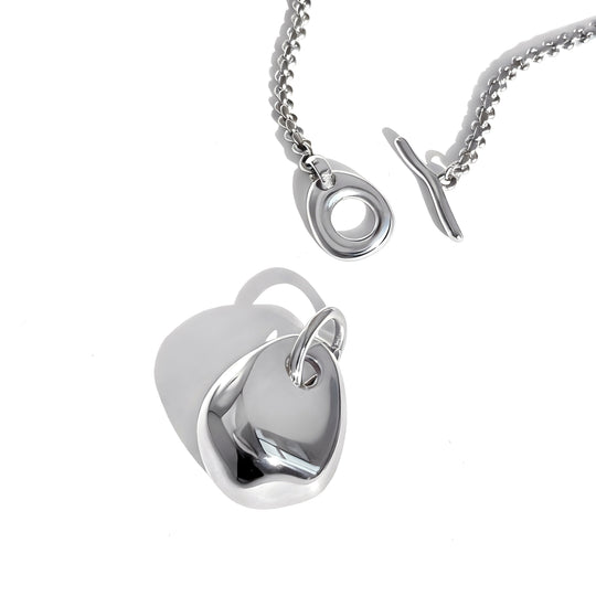 Modern silver pendant necklace with curved geometric design shown assembled and separated