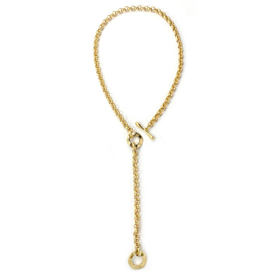 Gold chain lariat necklace with toggle clasp and circular pendant, laid flat overhead view