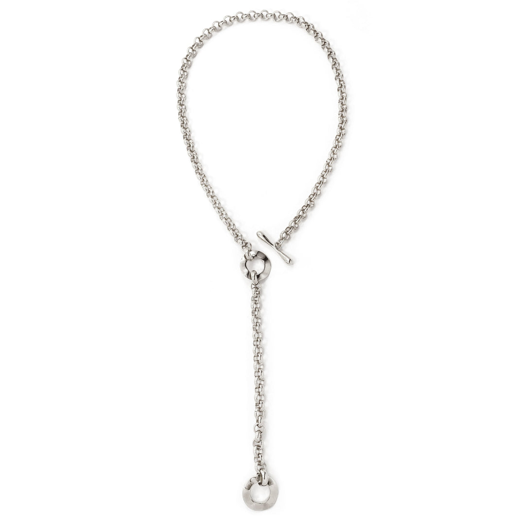 Silver chain lariat necklace with toggle clasp and circular pendant, laid flat overhead view