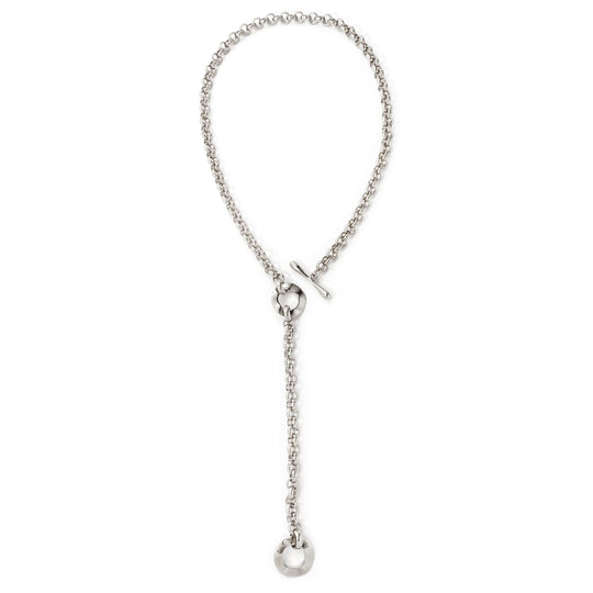 Silver chain lariat necklace with toggle clasp and circular pendant, laid flat overhead view
