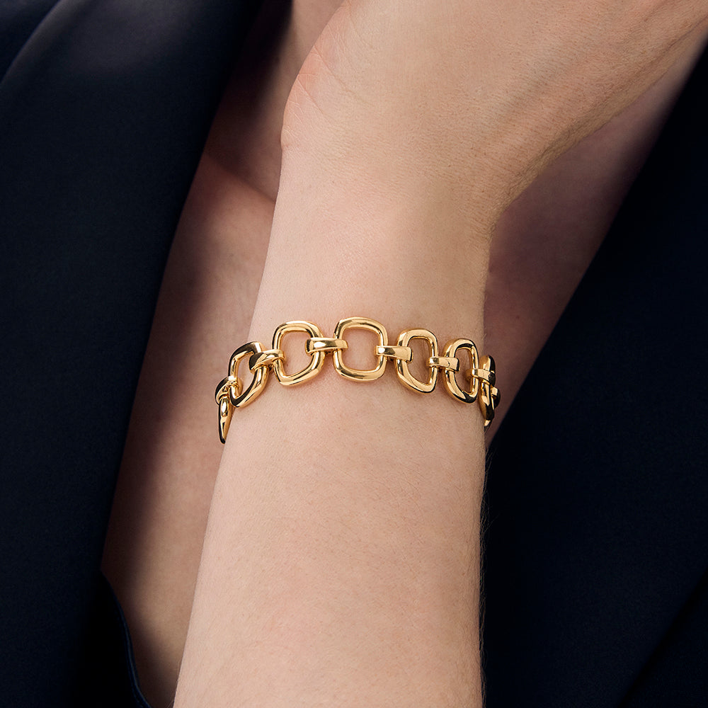 Gold link bracelet on wrist with chunky oval chain links