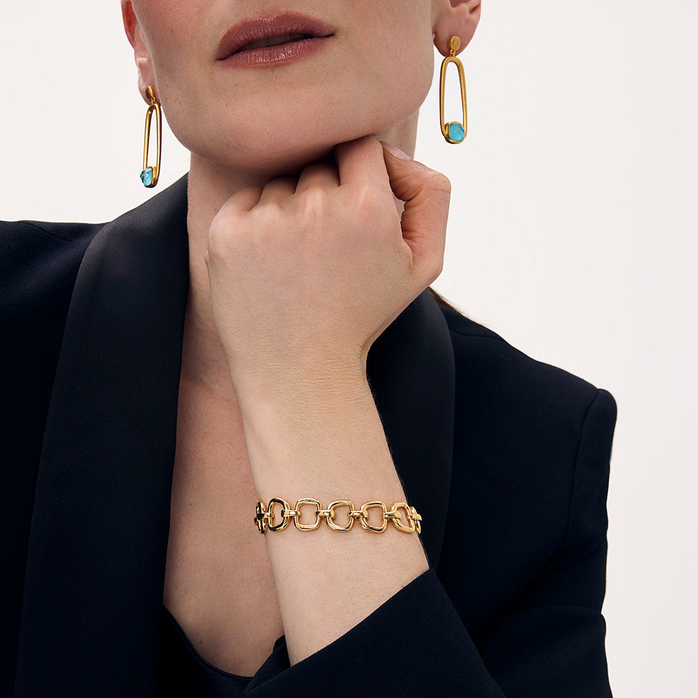 Gold link bracelet worn on model with chunky oval links