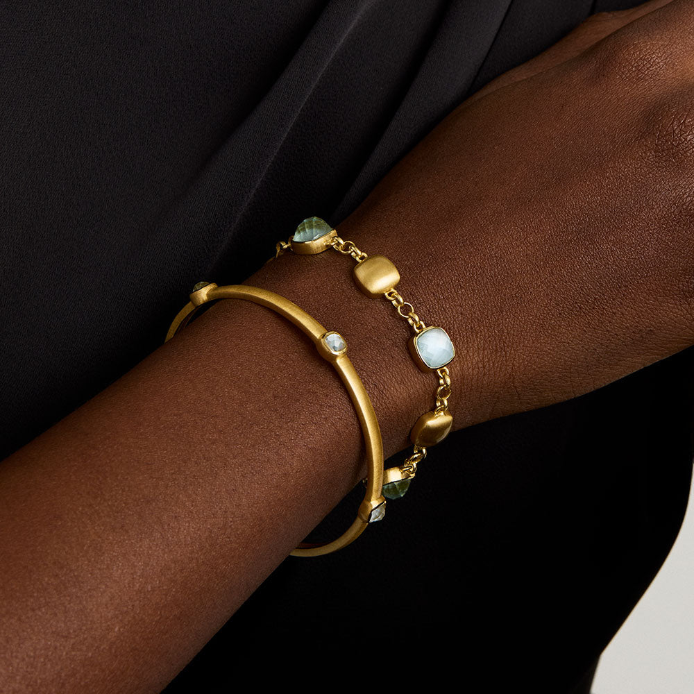 Gold-tone bracelet with light-blue iridescent beads and adjustable clasp detail