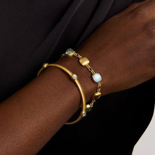 Gold-tone bracelet with light-blue iridescent beads and adjustable clasp detail