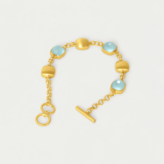 Gold-tone chain bracelet with light-blue iridescent beads, ring clasp, and T-bar charm