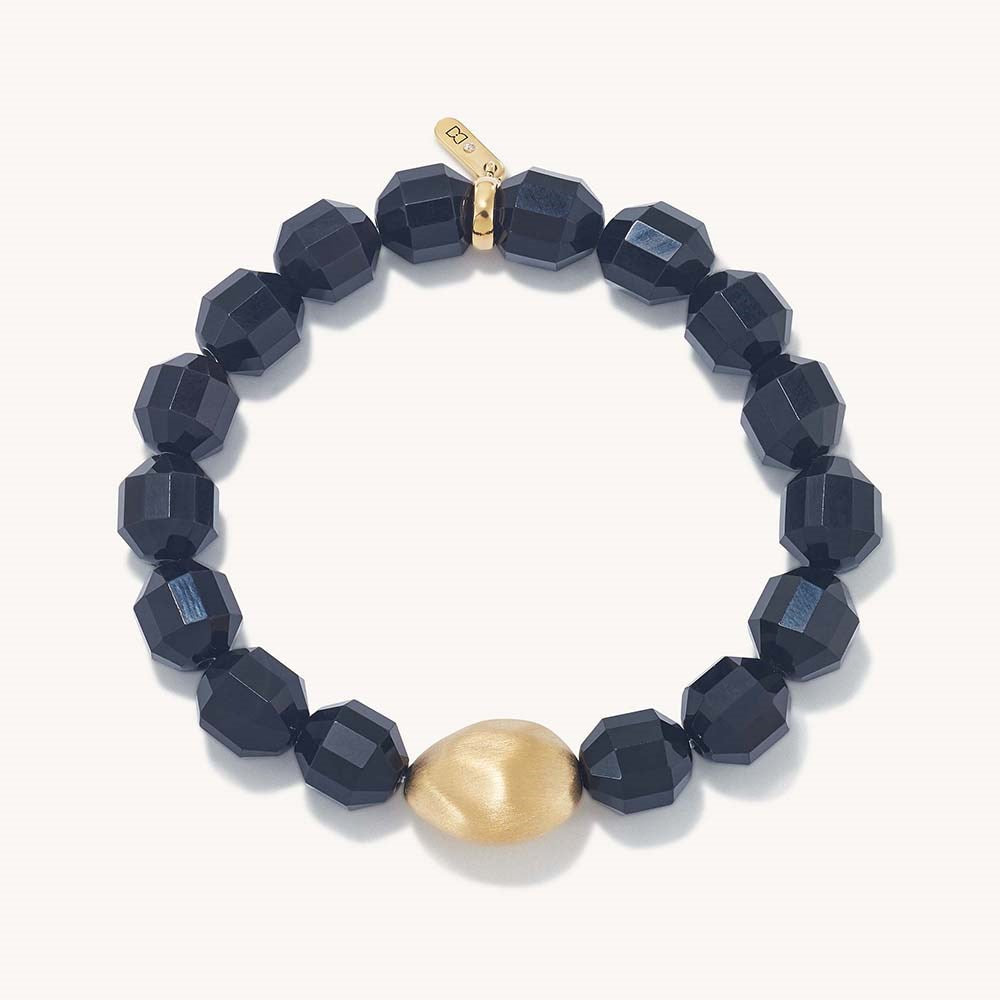 Black beaded bracelet with faceted cubes and gold teardrop charm