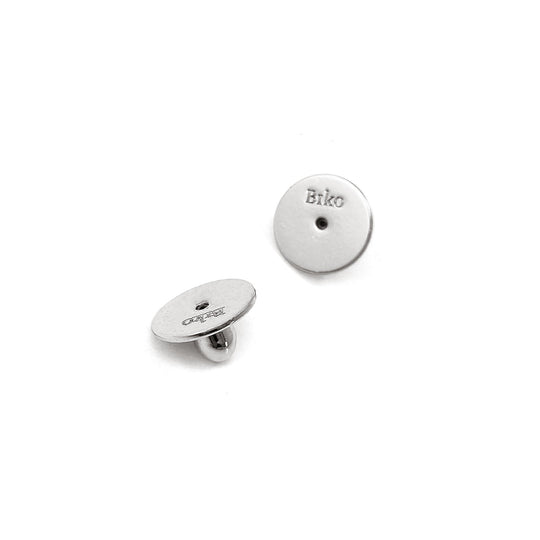 Silver circular stud earrings with small center hole, one showing front face, one showing back post