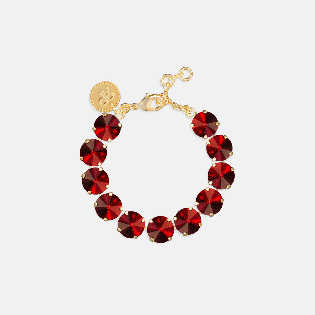Tennis bracelet with round deep red crystal stones in gold prong settings with lobster clasp