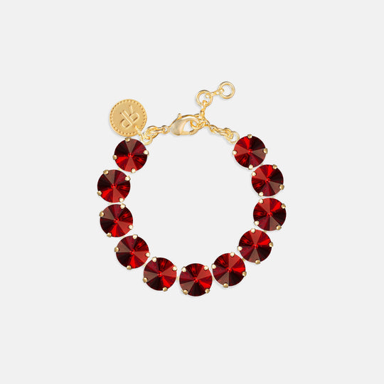 Tennis bracelet with round deep red crystal stones in gold prong settings with lobster clasp