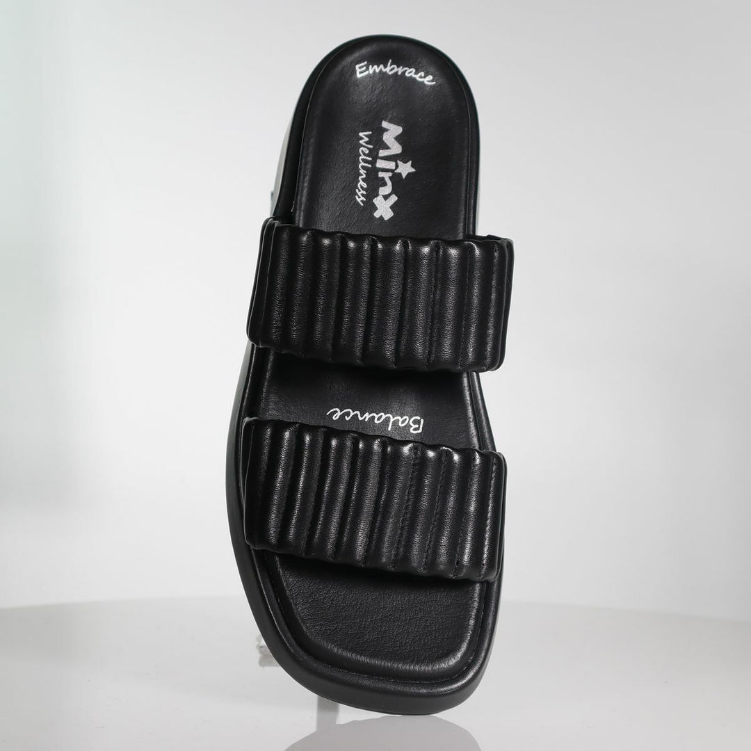 Black slide sandal with two ribbed straps and cushioned footbed, side angle view