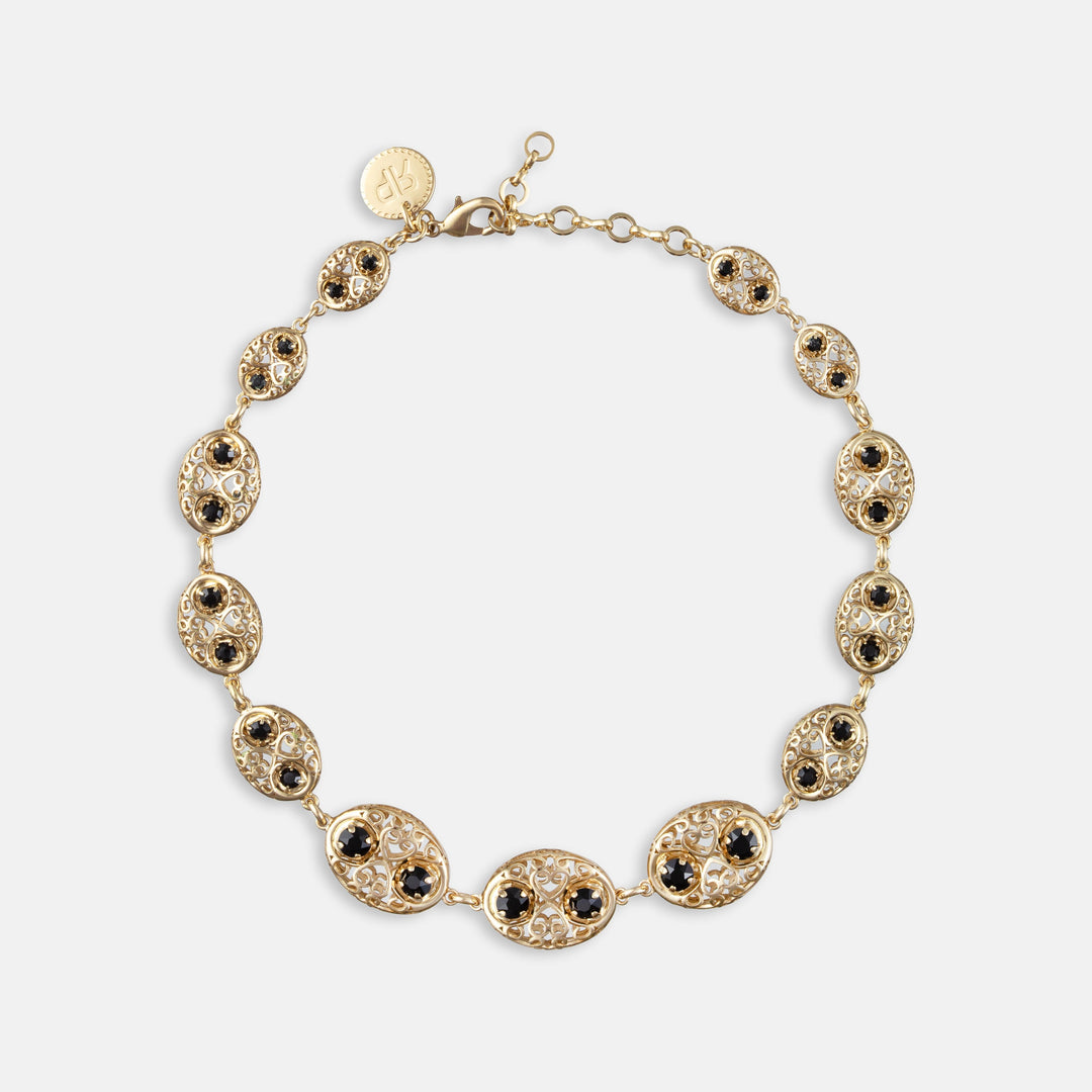 Gold filigree oval link necklace with black gemstone accents and lobster clasp