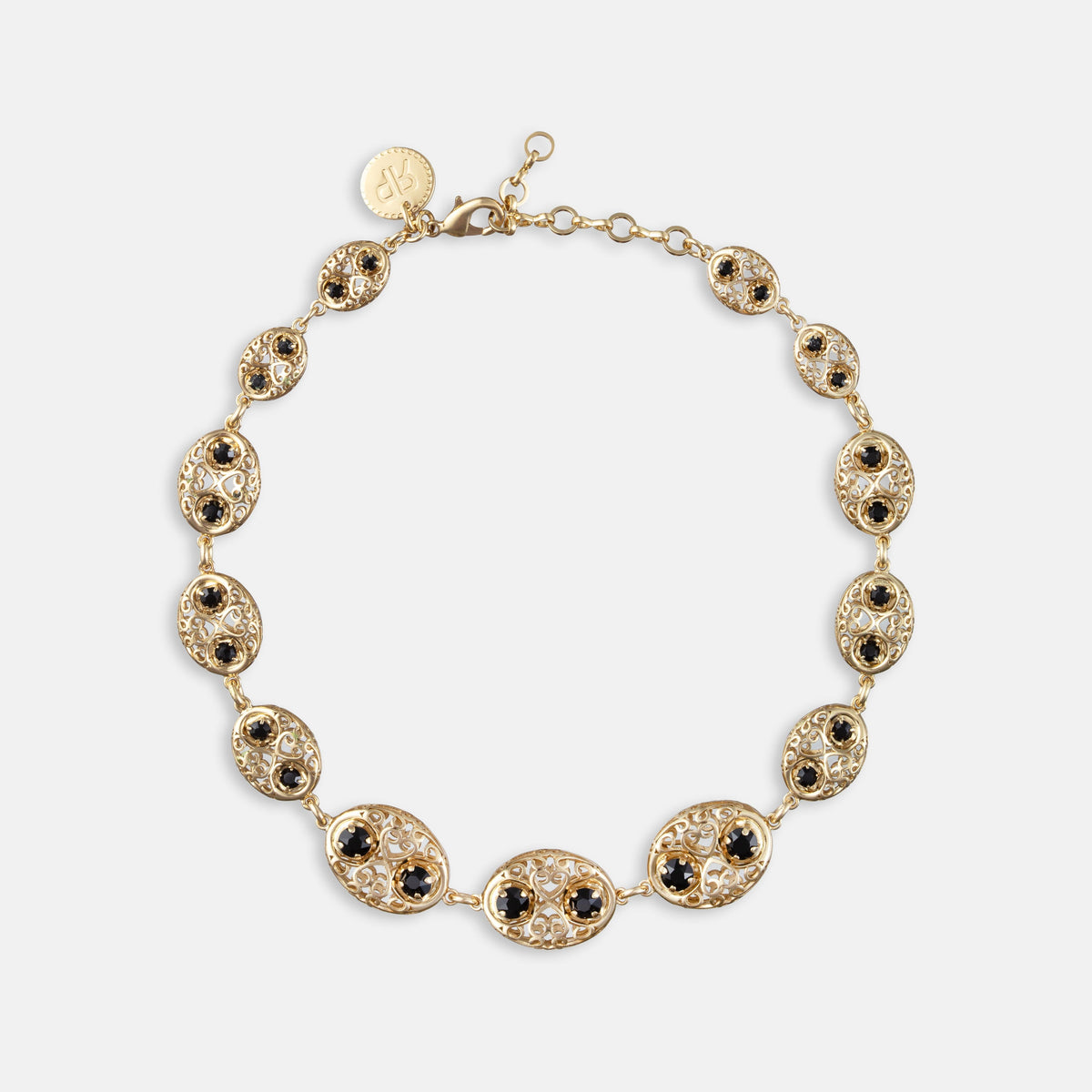 Gold-tone Roamy Jet necklace with oval black cabochon links and crystal-like details