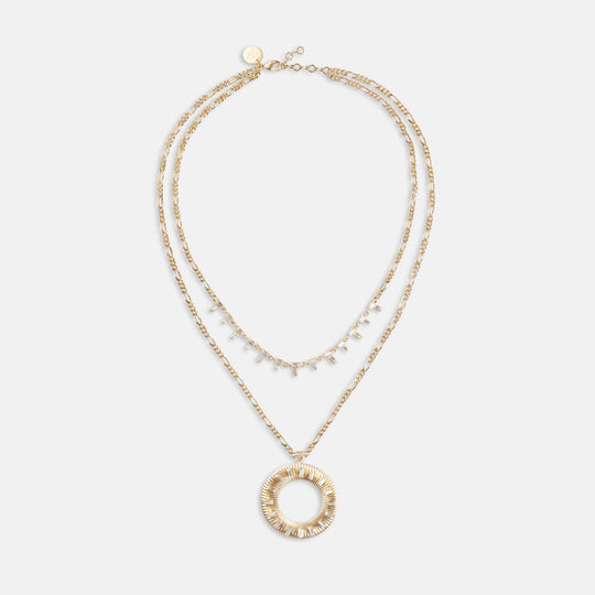 Layered gold necklace set with crystal baguette strand and large circular sunburst pendant