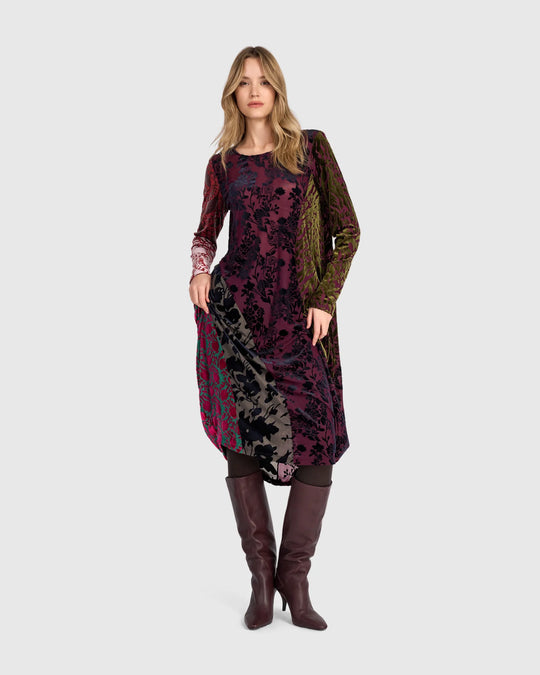 Burnout velvet mixed-print dress front view with long sleeves and curved asymmetric hem.
