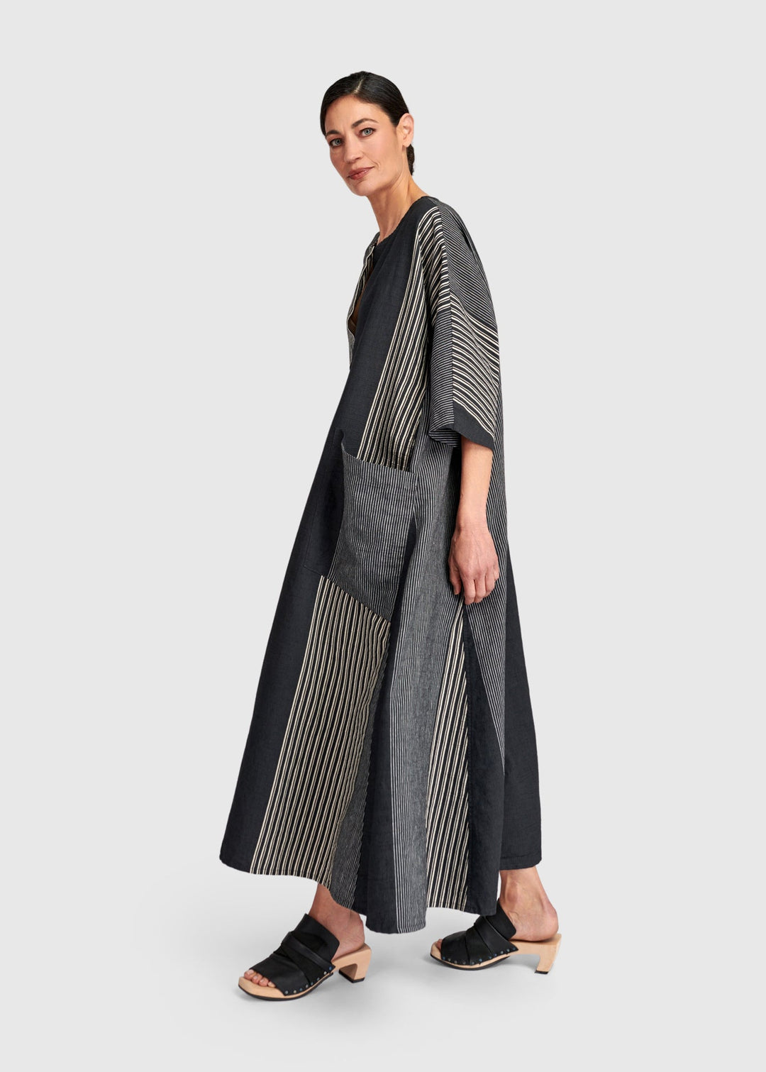 side view of plus size Alembika Maxi Striped Dress in Dark Bar