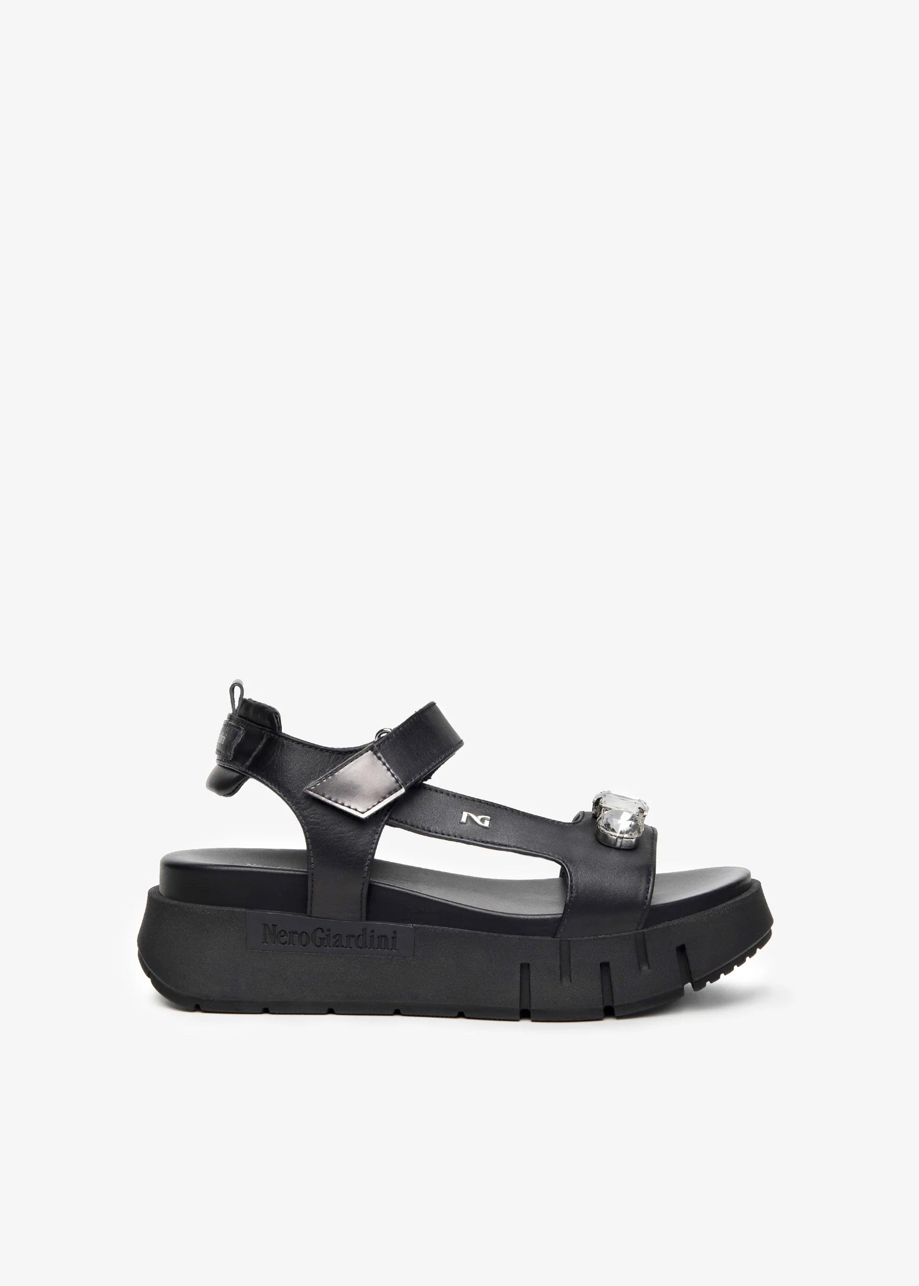 Black sandal with a platform sole on a white background