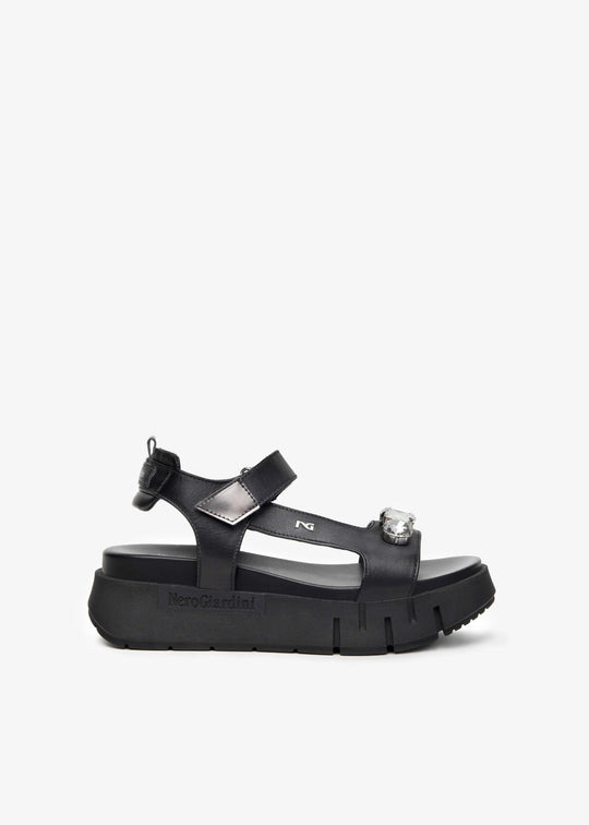Black sandal with a platform sole on a white background