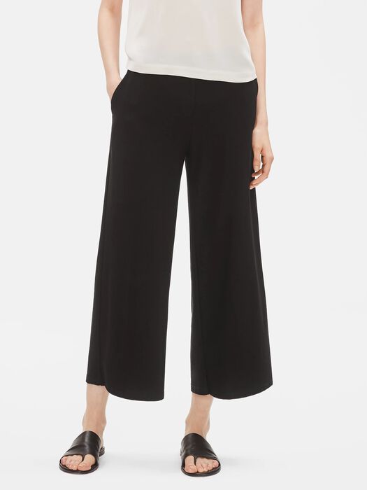 Black wide-leg ankle pants on model with white top and black sandals