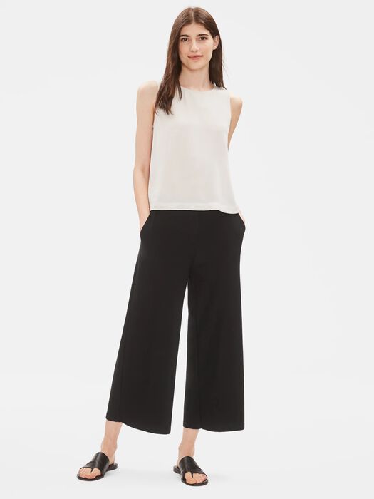 Wide-leg cropped pants in black worn with white sleeveless top