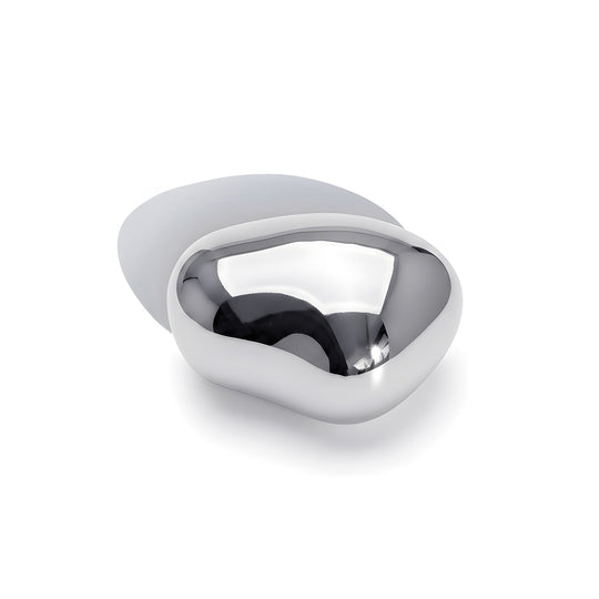 Modern sculptural brooch with curved silver metal design photographed from above